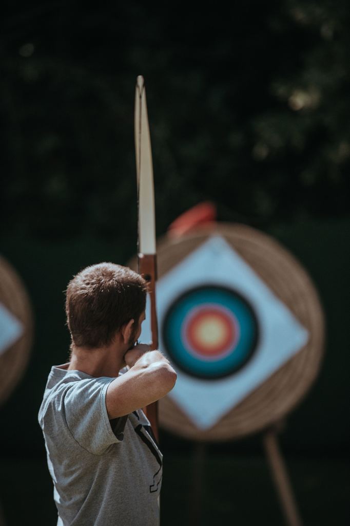 Archery, boy shooting at target. 